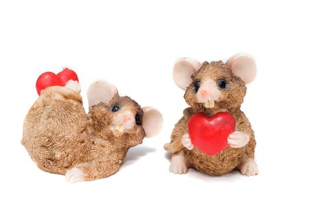 two mouse holding a hearts in arms isolated on whiteの写真素材
