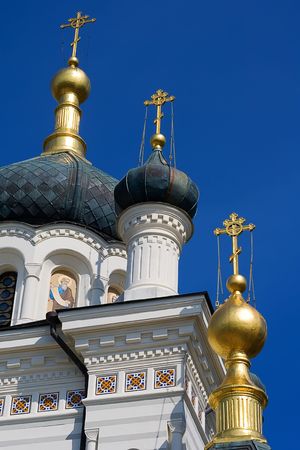 golden church domes over blue skyの写真素材