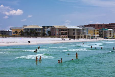 florida gulf coast beach with people swimingの写真素材