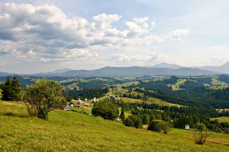 Rural landscape with hills and mountainsの写真素材
