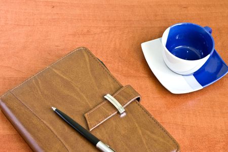 Office work place with notebook, pen and coffeの写真素材