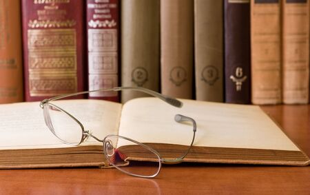book and glasses in libraryの写真素材