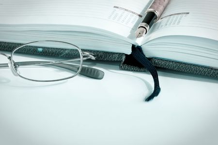 Business planner, glasses and penの写真素材