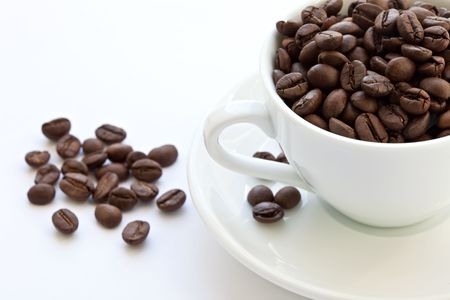 white cup with coffee beans isolatedの写真素材