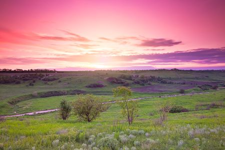 green farmland and beautiful sunsetの写真素材