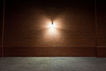 Old street light on a red brick wall.の写真素材