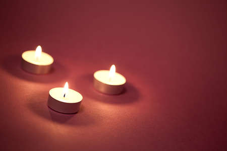 Three candles on a red background