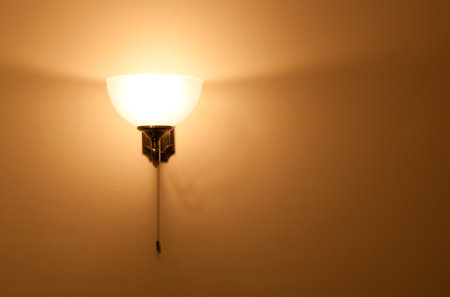 Lighted classic sconce on the wallの写真素材