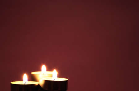 Three candles on a red background