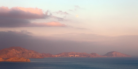 Beautiful coastal sunset with full moonの写真素材