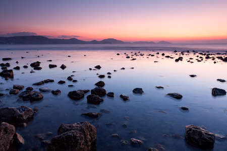 colorful sunrise on the rocky sea coastの写真素材