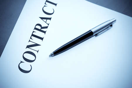 Close-up of pen and contract on the desk