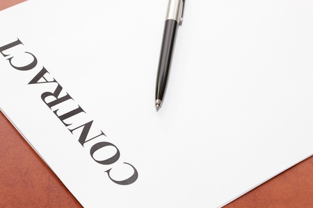 Close-up of pen and contract on the deskの写真素材