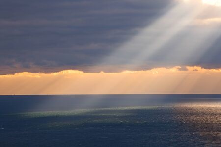 Sun ray through cloudsの写真素材