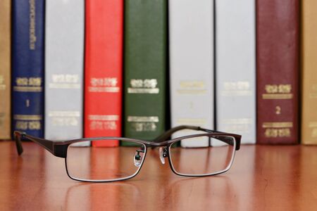 Glasses on the bookshelfの写真素材