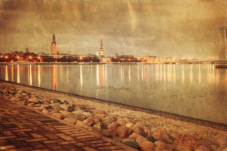 Retro style image of night Riga cityscape. Latviaの写真素材