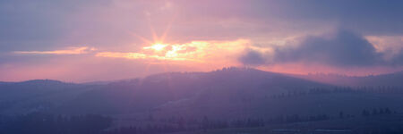Panoramic image of rising sun in Carpathian mountains, Ukraine