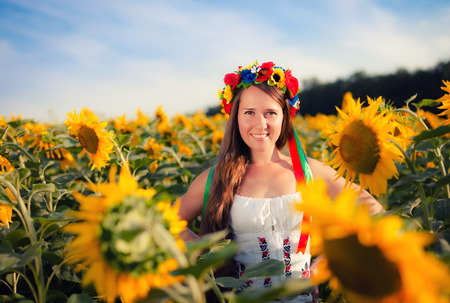 Close-up portrait of beautiful young woman with sunflowerの写真素材