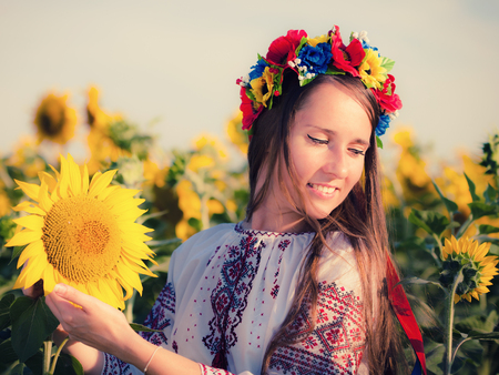 Beautiful young girl at sunflower field  Ukrainian girlの写真素材