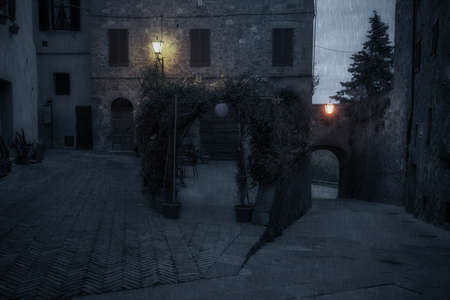 Old European street after dark. Pienza, Tuscany, Italy.の写真素材