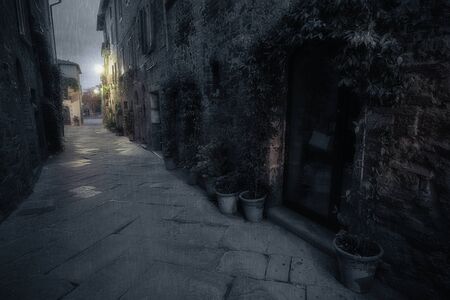 Old European street after dark. Pienza, Tuscany, Italy.の写真素材