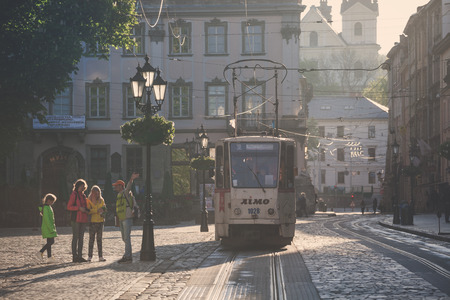 LVIV, UKRAINE - MAY 6, 2016: Morning streets of Lviv city. Old tram at street of the old city center.のeditorial素材