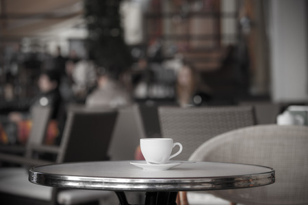 White cup of coffee at the summer cafe tableの写真素材