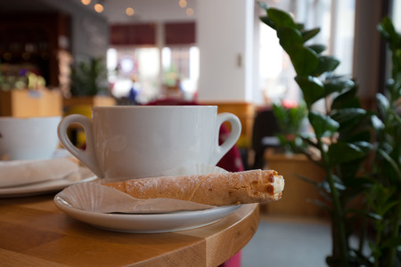 White cup of coffee at the cafe interiorの写真素材