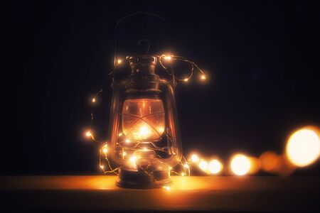 Vintage magic lantern with lights at night