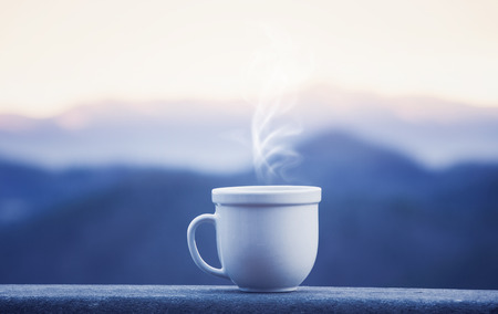 Morning coffee cup with alpine mountain viewの写真素材