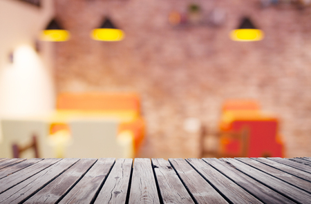 Wooden table top surface over blur kitchen cafe backgroundの写真素材