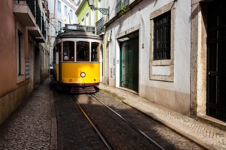 Traditional yellow tram at old streets, Lisbon old city, Portugalのeditorial素材