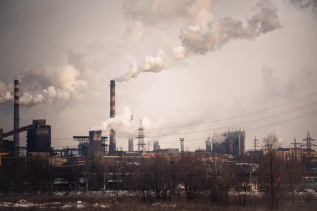 Heavy industry air pollution concept. Metallurgical plant smoke chimney