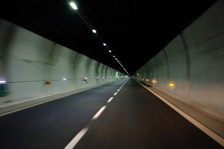 Blurred motion through dark tunnel