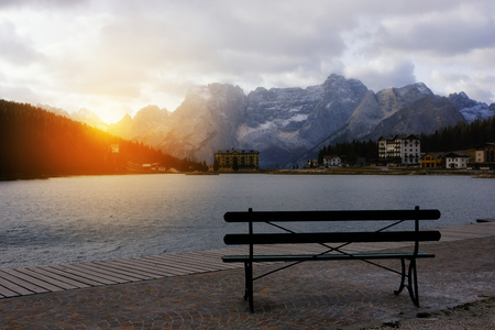 Bench with scenic alpine mountain lake view, Misurina lake, Dolomites Alps, Italyの写真素材