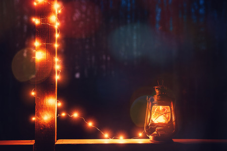 Vintage retro lantern with bokeh lights over dark background