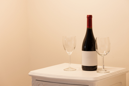 Wine bottle with wine glasses in a bedroom. Room service at the hotel.の写真素材
