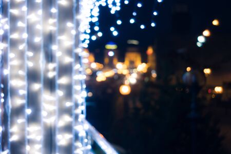 Blurred bokeh light background. Night city lights blur. Retro toned photo, vintage.の写真素材