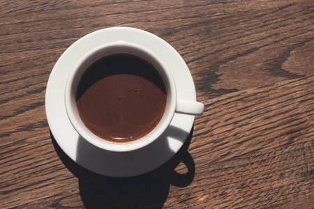 Cup of coffee on wooden table, top viewの写真素材
