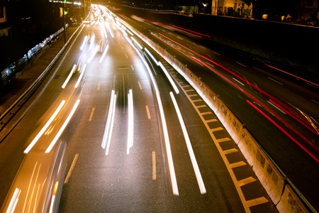 Night car city raffic. Motion blur car on the highway in big modern city.