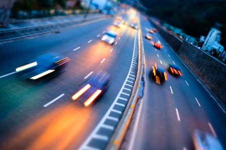 Night car traffic. Motion blur car viewed from the road bridge in big modern city.の写真素材