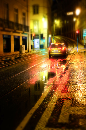 Urban night scene. Old European city illuminated street at night, Lisbon, Portugalの写真素材