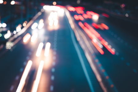 Light car trails bokeh light on the modern city street at nightの写真素材