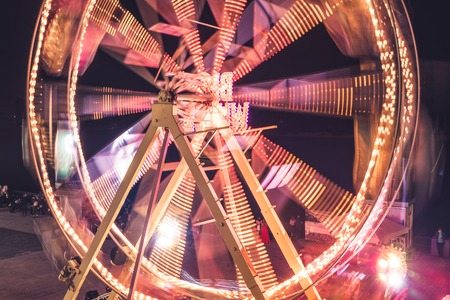 Ferris wheel in a night park. Entertainment in the carnival park.の写真素材