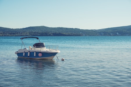 Beautiful Mediterranean landscape, mountains, sea and boat on the water. Montenegro, Adriatic Sea,...