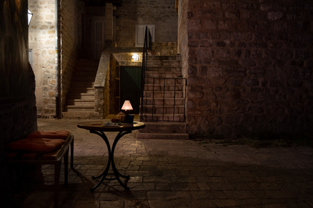Street cafe table at night. Old European city viewの写真素材