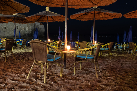 Romantic dinner table on tropical beach at nightの写真素材