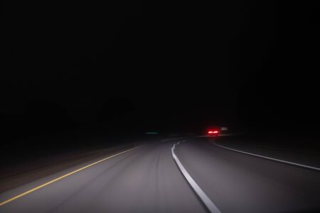 Fast night driving on highway, view from inside of a carの写真素材