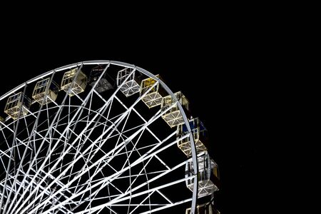 Ferris wheel in a night park. Entertainment in the carnival park.の写真素材