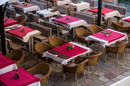 View of empty tables in outdoor cafe on the street european street